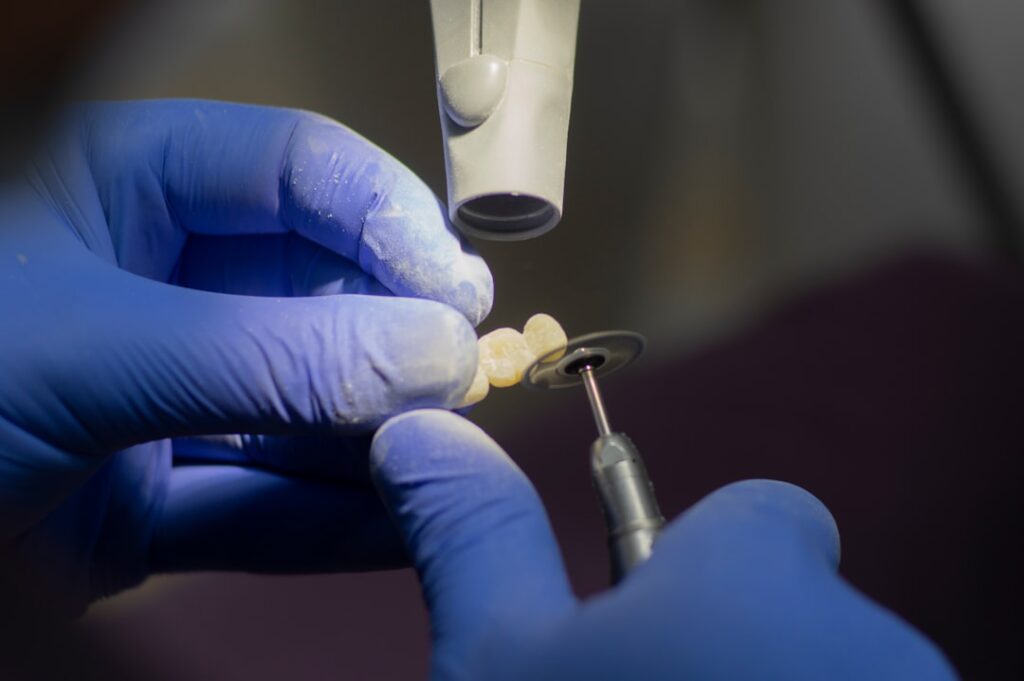 A dentist showing a dental implant model to a middle-aged patient in a dental office